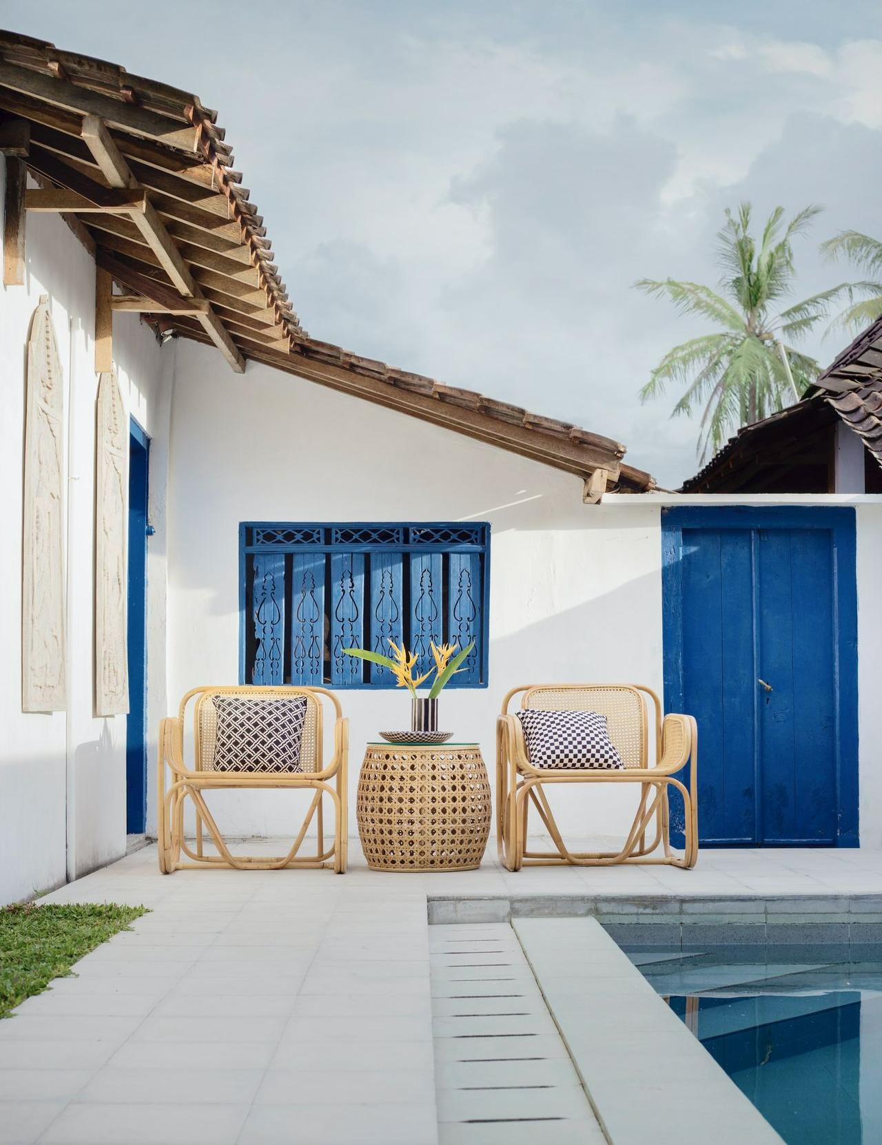 wicker table and two chairs near swimming pool